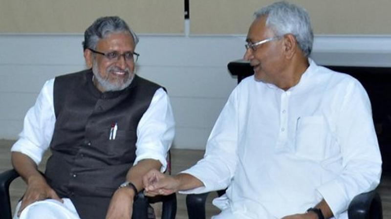Bihar Chief Minister Nitish Kumar with senior leader of BJP Sushil Kumar Modi at legislators meeting in Patna on Wednesday. (Photo: PTI) Bihar Chief Minister Nitish Kumar with senior leader of BJP Sushil Kumar Modi at legislators meeting in Patna on Wednesday. (Photo: PTI)