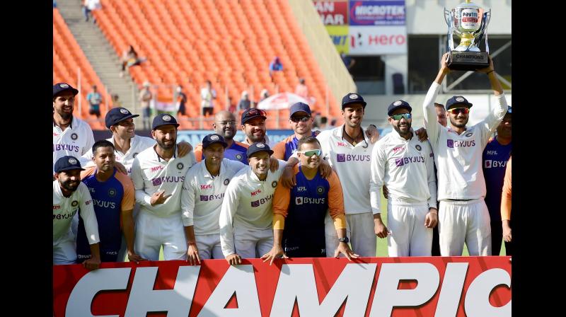 Indian cricket team players pose with the trophy after defeating England in the third day’s play of the 4th Test at Narendra Modi Stadium in Ahmedabad on Saturday. -- PTI Indian cricket team players pose with the trophy after defeating England in the third day’s play of the 4th Test at Narendra Modi Stadium in Ahmedabad on Saturday. -- PTI