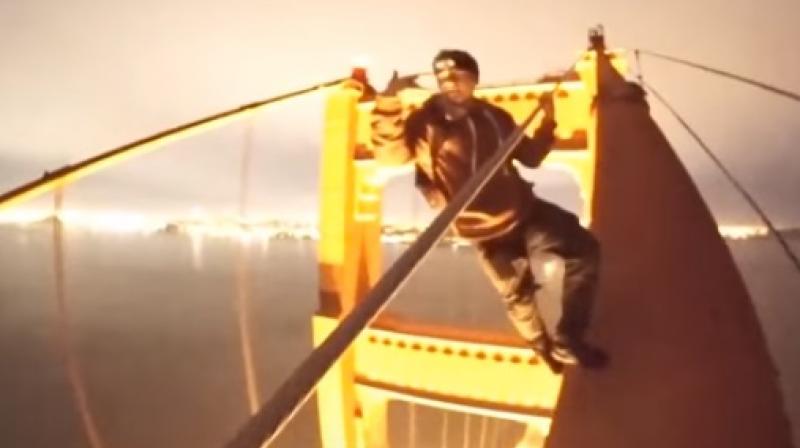 The daredevil boys climbed the 745-foot bridge without any fear and performed several stunts and even took a selfie while walking upwards. (Photo: Youtube) The daredevil boys climbed the 745-foot bridge without any fear and performed several stunts and even took a selfie while walking upwards. (Photo: Youtube)