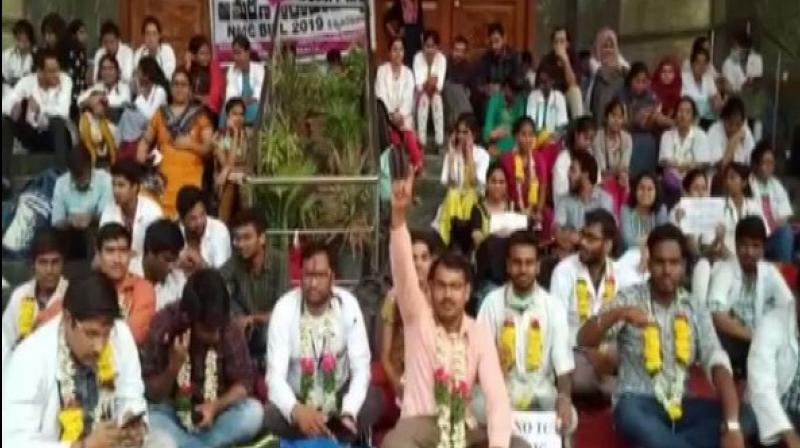 Junior doctors in a Hyderabad-based hospital on Friday boycotted their medical practices and continued to stage protest opposing the National Medical Commission (NMC) Bill passed by the Parliament. (Photo: ANI) Junior doctors in a Hyderabad-based hospital on Friday boycotted their medical practices and continued to stage protest opposing the National Medical Commission (NMC) Bill passed by the Parliament. (Photo: ANI)