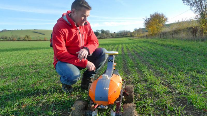 Methodically inspecting Butler's winter wheat crop for weeds and pests, the laborer doesn't complain or even break a sweat. That's because it's a four-wheel robot dubbed "Tom" that uses GPS, artificial intelligence and smartphone technology to digitally map the field. (Photo: AP) Methodically inspecting Butler's winter wheat crop for weeds and pests, the laborer doesn't complain or even break a sweat. That's because it's a four-wheel robot dubbed "Tom" that uses GPS, artificial intelligence and smartphone technology to digitally map the field. (Photo: AP)