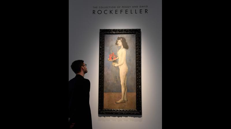 A man looks at the painting "Fillette à la corbeille fleurie" 1905 by late Spanish painter Pablo Picasso at Christie's France, as part of a presentation of the collection Rockefeller in Paris on March 13, 2018, before the sale at Christie's New York. (Photo: AFP) A man looks at the painting "Fillette à la corbeille fleurie" 1905 by late Spanish painter Pablo Picasso at Christie's France, as part of a presentation of the collection Rockefeller in Paris on March 13, 2018, before the sale at Christie's New York. (Photo: AFP)