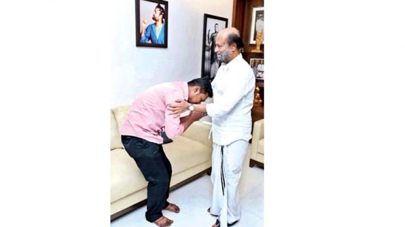 Rajinikanth consoling Vijayakumar, father of the two kids poisoned by his wife. (Image: DC) Rajinikanth consoling Vijayakumar, father of the two kids poisoned by his wife. (Image: DC)