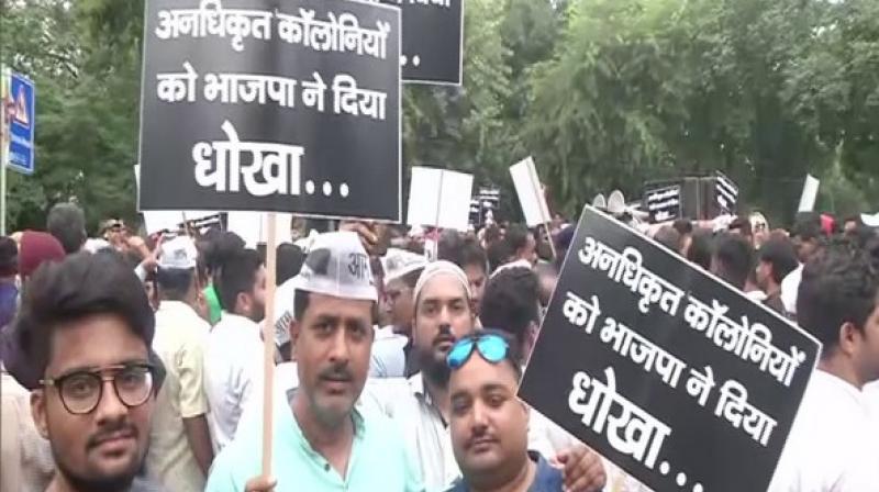 The AAP party workers chanted slogans against Prime Minister Narendra Modi and his government, claiming that the BJP had betrayed the people of Delhi as the impending promise of regularisation of the unauthorised colonies is yet to be fulfilled. (Photo: ANI) The AAP party workers chanted slogans against Prime Minister Narendra Modi and his government, claiming that the BJP had betrayed the people of Delhi as the impending promise of regularisation of the unauthorised colonies is yet to be fulfilled. (Photo: ANI)