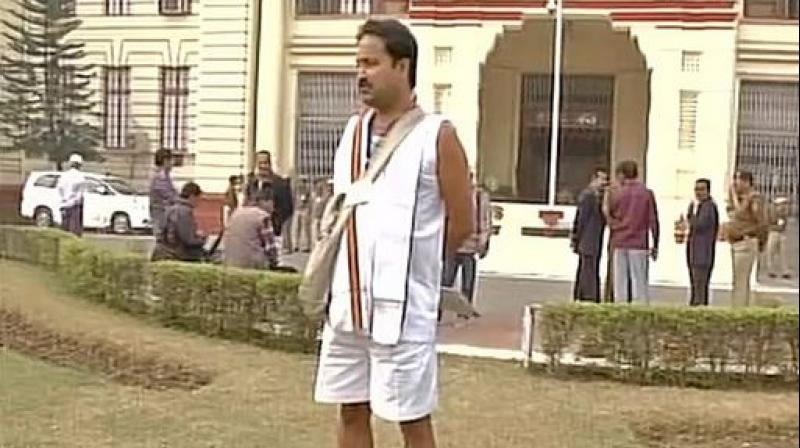 BJP MLA Binay Bihari arrived in Bihar Vidhan Sabha wearing vest and shorts to protest against delay in construction of road in his assembly area. (Photo: ANI/Twitter) BJP MLA Binay Bihari arrived in Bihar Vidhan Sabha wearing vest and shorts to protest against delay in construction of road in his assembly area. (Photo: ANI/Twitter)
