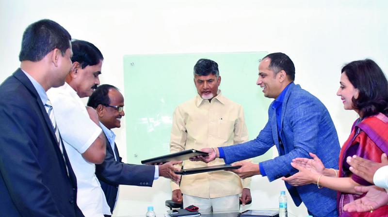Officials of the Government of AP and Monetary Authority of Singapore sign an MoU on Fintech in the presence of Chief Minister N. Chandrababu Naidu at his house in Vijayawada on Saturday. (Photo: DC) Officials of the Government of AP and Monetary Authority of Singapore sign an MoU on Fintech in the presence of Chief Minister N. Chandrababu Naidu at his house in Vijayawada on Saturday. (Photo: DC)