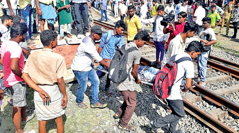Commuters and students take one of the injured persons out of the railway track in Chennai on Tuesday (Photo: DC) Commuters and students take one of the injured persons out of the railway track in Chennai on Tuesday (Photo: DC)