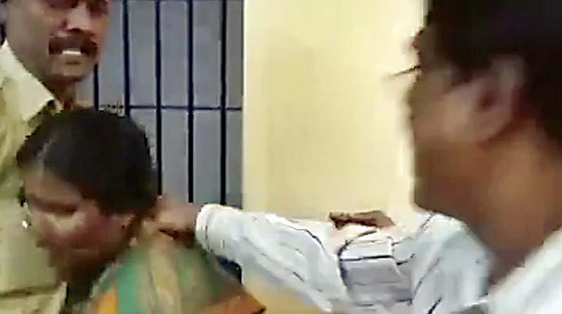 Screen grab of cops hitting a woman at Kumarswamy Layout police station Screen grab of cops hitting a woman at Kumarswamy Layout police station