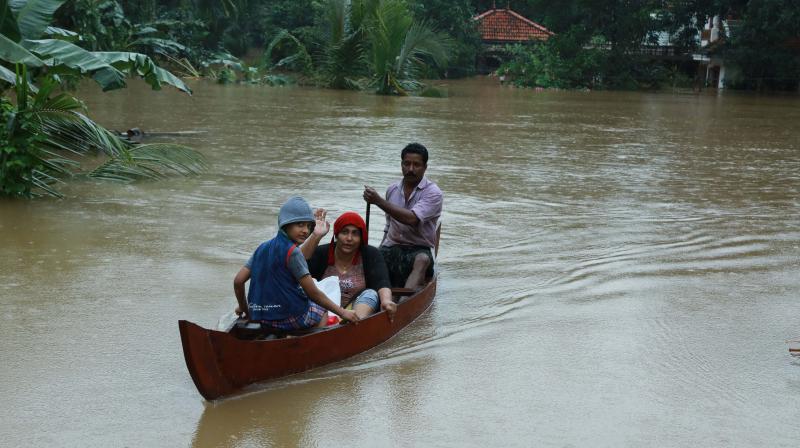 A family affected by the floods being rescued at Muvattupuzha in Ernakulam district on Thursday ( Image: ARUN CHANDRABOSE) A family affected by the floods being rescued at Muvattupuzha in Ernakulam district on Thursday ( Image: ARUN CHANDRABOSE)