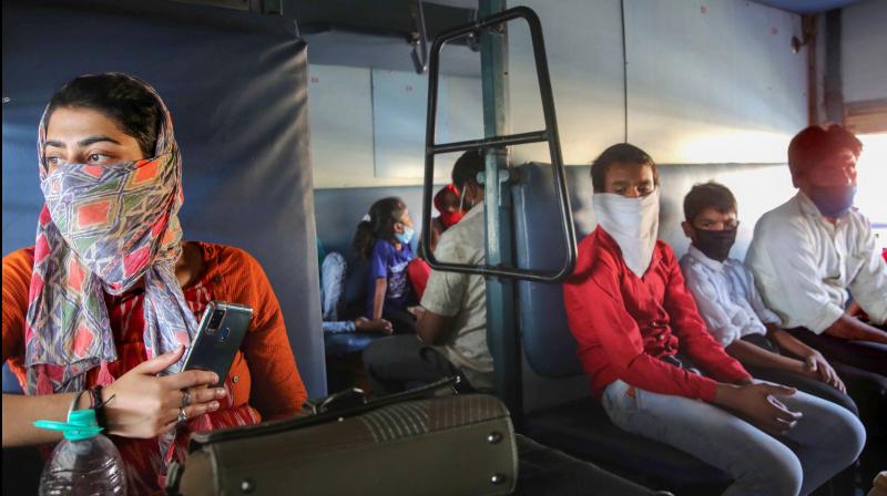 Migrants sit in a special train for Udhampur in Jammu and Kashmir, during covid-19 lockdown, at Habibganj Railway Station in Bhopal. PTI Photo