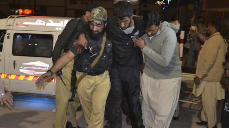 A Pakistani volunteer and a police officer rush an injured person to a hospital in Quetta, Pakistan. (Photo: AP) A Pakistani volunteer and a police officer rush an injured person to a hospital in Quetta, Pakistan. (Photo: AP)