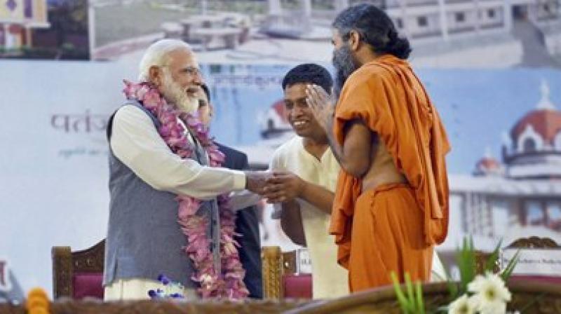 Narendra Modi being welcomed by Swami Ramdev and Balkrishan at the inauguration of the Patanjali Research Institute in Haridwar, Uttarakhand on Wednesday. (Photo: PTI) Narendra Modi being welcomed by Swami Ramdev and Balkrishan at the inauguration of the Patanjali Research Institute in Haridwar, Uttarakhand on Wednesday. (Photo: PTI)
