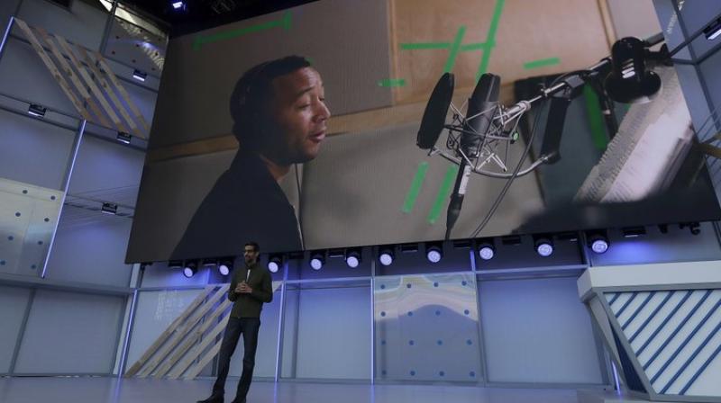 Google CEO Sundar Pichai speaks under a video showing singer John Legend at the Google I/O conference in Mountain View, Calif., Tuesday, May 8, 2018. (AP Photo/Jeff Chiu) Google CEO Sundar Pichai speaks under a video showing singer John Legend at the Google I/O conference in Mountain View, Calif., Tuesday, May 8, 2018. (AP Photo/Jeff Chiu)
