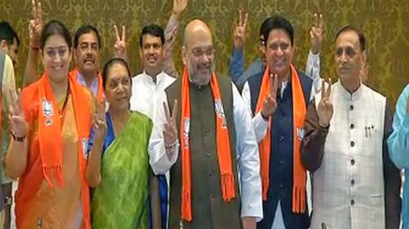 Textile and I&B minister Smriti Irani (L) with Bharatiya Janata Party President Amit Shah (centre). (Photo: ANI) Textile and I&B minister Smriti Irani (L) with Bharatiya Janata Party President Amit Shah (centre). (Photo: ANI)