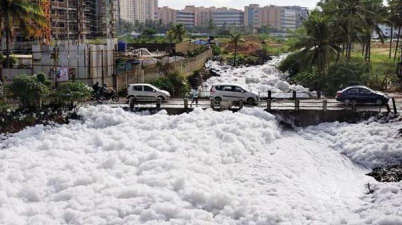 Cars move past the foaming lake in Bengaluru. (Photo: File) Cars move past the foaming lake in Bengaluru. (Photo: File)