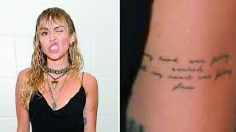 Miley Cyrus and her new breakup tattoo Miley Cyrus and her new breakup tattoo