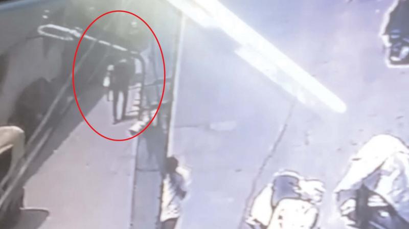 The CCTV footage, which shows the boy carrying the baby The CCTV footage, which shows the boy carrying the baby