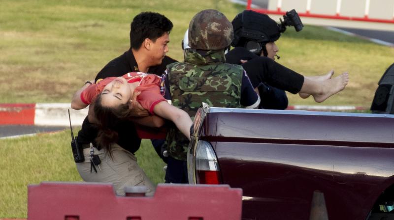 Soldiers carry a person out of Terminal 21 Korat mall in Nakhon Ratchasima, Thailand, Sunday, Feb. 9, 2020. A gunman described as a soldier angry over a financial dispute killed a few people and then went on a far bloodier rampage Saturday in northeastern Thailand, shooting as he drove to the busy mall where shoppers fled in terror. (AP)