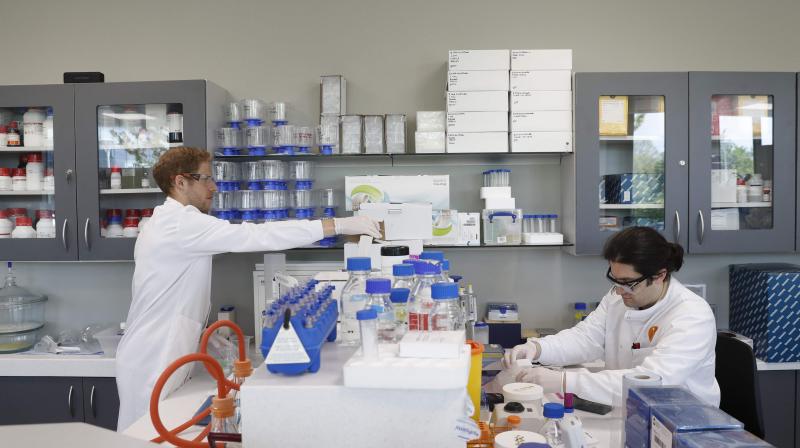 Drug discovery scientist Phillipp Schafer (L) and protein scientist Simon Varzandeh work in the laboratory of British pharmatech company Exscientia at Oxford Science Park in Oxford, in southern central England. AFP Photo