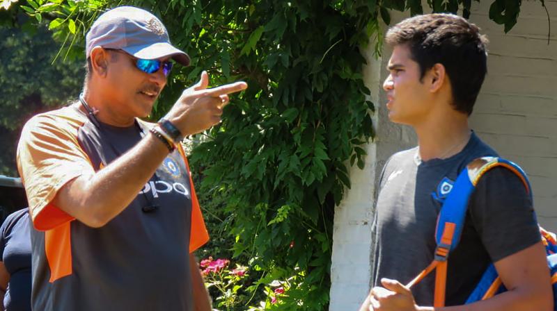 Indian cricket teams chief coach Ravi Shastri has a word with Arjun Tendulkar. PTI Photo