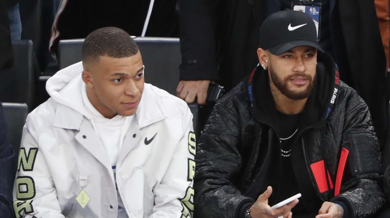 Paris St Germains players Kylian Mbappe (L) and Neymar attend the Milwaukee Bucks vs Charlotte Hornets NBA game in Paris. AP Photo