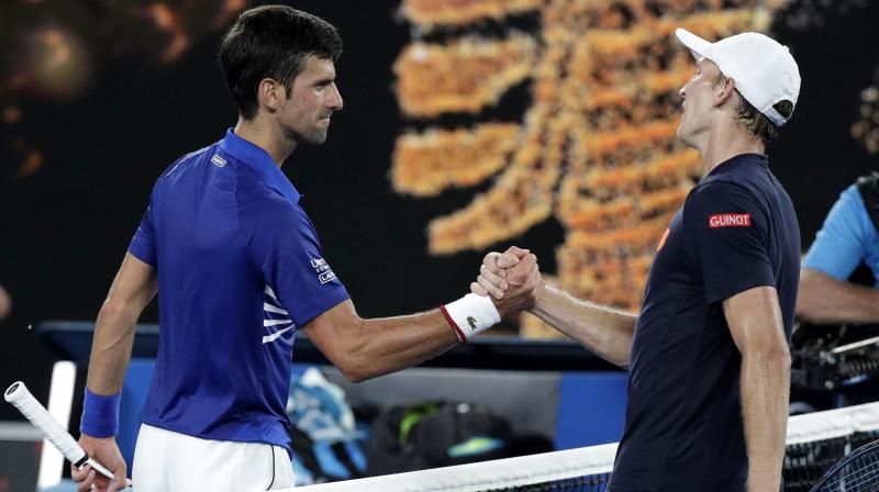 Serbias Novak Djokovic (L) is congratulated by United States Mitchell Krueger after their first round match at the Australian Open tennis championships in Melbourne, Australia. AP Photo