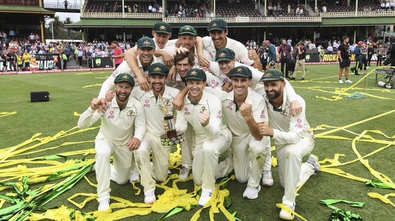 Australian team with the Trans-Tasman Trophy after winning the Test match and series on day four of the third cricket Test against New Zealand at the Sydney Cricket Ground, Australia. AP Photo