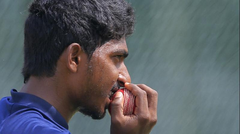 Sri Lankas bowler Lakshan Sandakan bites the ball during a training session in Colombo, Sri Lanka. AP Photo