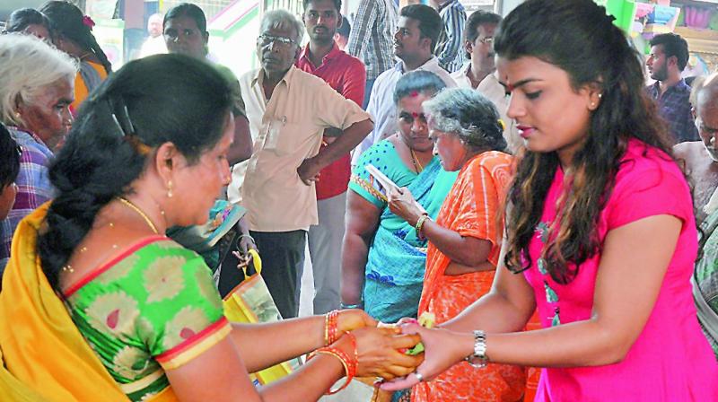 A woman gives prasadam to a girl at Mulastaneswara Swamy temple in Nellore on Monday. (Photo: DC) A woman gives prasadam to a girl at Mulastaneswara Swamy temple in Nellore on Monday. (Photo: DC)