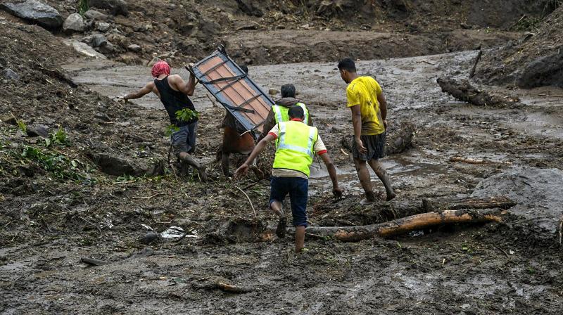Rescue workers and local people engage in rescue works at landslide seen at Kattippara in Kozhikode on Thursday. (Photo: PTI) Rescue workers and local people engage in rescue works at landslide seen at Kattippara in Kozhikode on Thursday. (Photo: PTI)