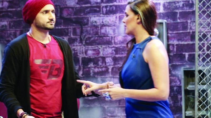 Actress Neha Dhupia and cricketer Harbhajan Singh argue on the show Roadies Rising. Actress Neha Dhupia and cricketer Harbhajan Singh argue on the show Roadies Rising.