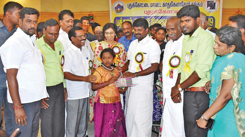 State Health minister Dr C. Vijayabaskar distributes hearing aid to a needy girl at the 10th anniversary of the district Deaf and Dumb school at Pudukkottai on Sunday, in the presence of district collector, Ms B. Umamaheswari and others. (Photo: DC) State Health minister Dr C. Vijayabaskar distributes hearing aid to a needy girl at the 10th anniversary of the district Deaf and Dumb school at Pudukkottai on Sunday, in the presence of district collector, Ms B. Umamaheswari and others. (Photo: DC)