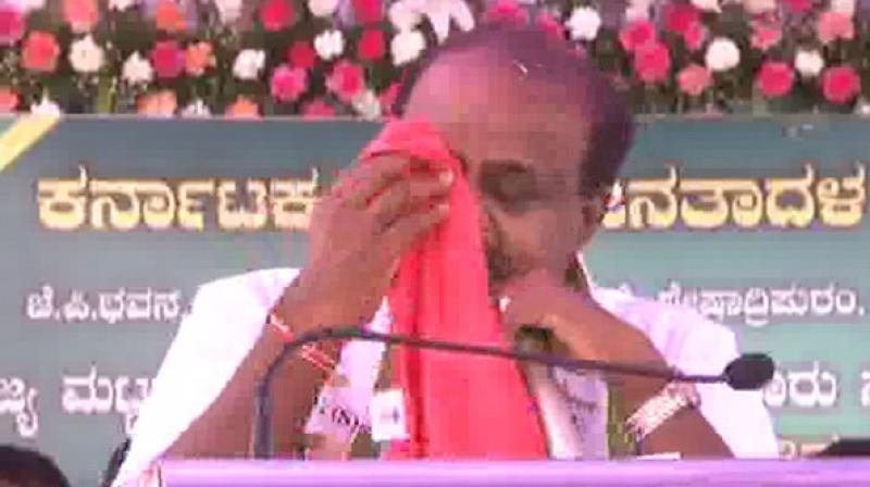 Throughout his address, HD Kumaraswamy was teary-eyed and repeatedly kept wiping his tears away with a handkerchief. (Photo: ANI) Throughout his address, HD Kumaraswamy was teary-eyed and repeatedly kept wiping his tears away with a handkerchief. (Photo: ANI)