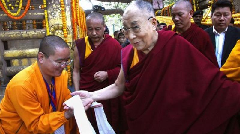 Devotees pay respects to Tibetan spiritual leader Dalai Lama at the Mahabodhi temple. (Photo: AP) Devotees pay respects to Tibetan spiritual leader Dalai Lama at the Mahabodhi temple. (Photo: AP)