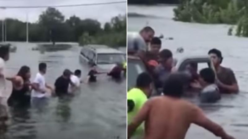 Human chain saves man trapped in car by floods in Texas. (Photo: Youtube) Human chain saves man trapped in car by floods in Texas. (Photo: Youtube)