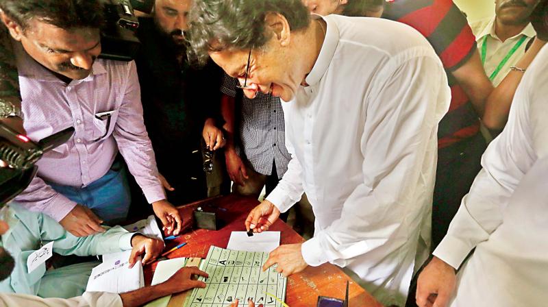 Tehreek-e-Insaf party chief Imran Khan casts his vote at a polling station in Islamabad, on Wednesday. (Photo: AP) Tehreek-e-Insaf party chief Imran Khan casts his vote at a polling station in Islamabad, on Wednesday. (Photo: AP)