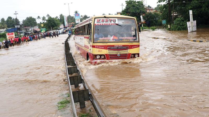 An RTC bus tries to navigate through the heavily flooded Chalakudy-Muringoor national highway on Thursday. (Image ANUP K. VENU) An RTC bus tries to navigate through the heavily flooded Chalakudy-Muringoor national highway on Thursday. (Image ANUP K. VENU)
