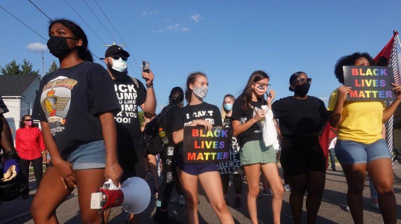 Demonstrators protesting the shooting of Jacob Blake march through a neighborhood on August 27, 2020 in Kenosha, Wisconsin. (AFP)