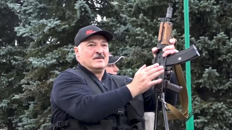 Belarus President Alexander Lukashenko armed with a Kalashnikov-type rifle near the Palace of Independence in Minsk, Belarus. (AP)