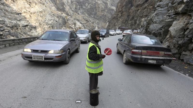 11-year-old Sedaqat signals vehicles on the Maipur Pass, along the main highway from Kabul to Pakistan, near Kabul, Afghanistan. (Photo: AP) 11-year-old Sedaqat signals vehicles on the Maipur Pass, along the main highway from Kabul to Pakistan, near Kabul, Afghanistan. (Photo: AP)