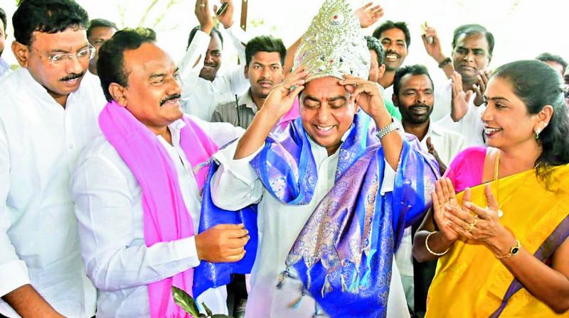 Khanapur MLA Ajmeera Rekha Naik who aspires for a ministry in the second phase of the Cabinet expansion offers a crown to endowments minister Allola Indrakran Reddy at a party meeting recently held in Khanapur, Nirmal district. — DC Khanapur MLA Ajmeera Rekha Naik who aspires for a ministry in the second phase of the Cabinet expansion offers a crown to endowments minister Allola Indrakran Reddy at a party meeting recently held in Khanapur, Nirmal district. — DC