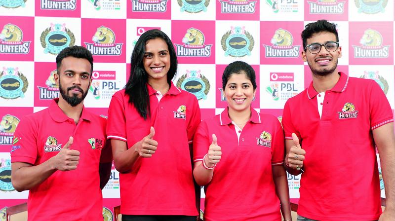 Ace shuttler P. V. Sindhu (second from left) poses with her teammates from the Hyderabad Hunters Arun George (left), Meghana Jakkampudi (second from right) and Rahul Yadav (right) during a press conference in Hyderabad on Monday. Ace shuttler P. V. Sindhu (second from left) poses with her teammates from the Hyderabad Hunters Arun George (left), Meghana Jakkampudi (second from right) and Rahul Yadav (right) during a press conference in Hyderabad on Monday.