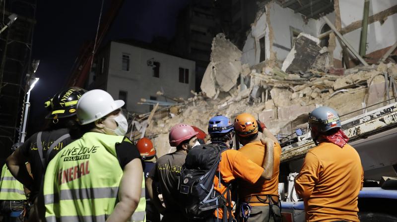 Lebanese and Chilean rescuers watching a crane at the site of a collapsed building after getting signals there may be a survivor buried in the rubble, early Friday, Sept. 4, 2020, in Beirut, Lebanon.(AP)