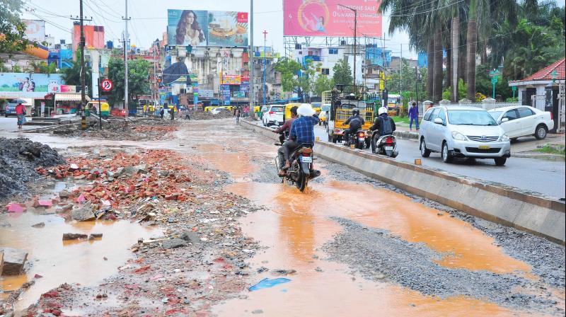 A stretch of potholes and puddles, denies access to a petrol bunk near Koramangala 6th Block. A stretch of potholes and puddles, denies access to a petrol bunk near Koramangala 6th Block.