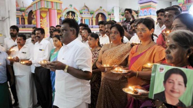 AIADMK MLA Amman Arjunan along with party members offering prayers for the recovery of Tamil Nadu CM Jayalalithaa, in Coimbatore on Saturday. (Photo: PTI) AIADMK MLA Amman Arjunan along with party members offering prayers for the recovery of Tamil Nadu CM Jayalalithaa, in Coimbatore on Saturday. (Photo: PTI)
