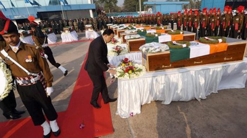 MoS for Defence Subhash R Bhamre paying homage at the coffins of their colleagues killed in the recent avalanches in Gurez Sector, after they were flown to AFS Palam in New Delhi from J & K. (Photo: AP) MoS for Defence Subhash R Bhamre paying homage at the coffins of their colleagues killed in the recent avalanches in Gurez Sector, after they were flown to AFS Palam in New Delhi from J & K. (Photo: AP)