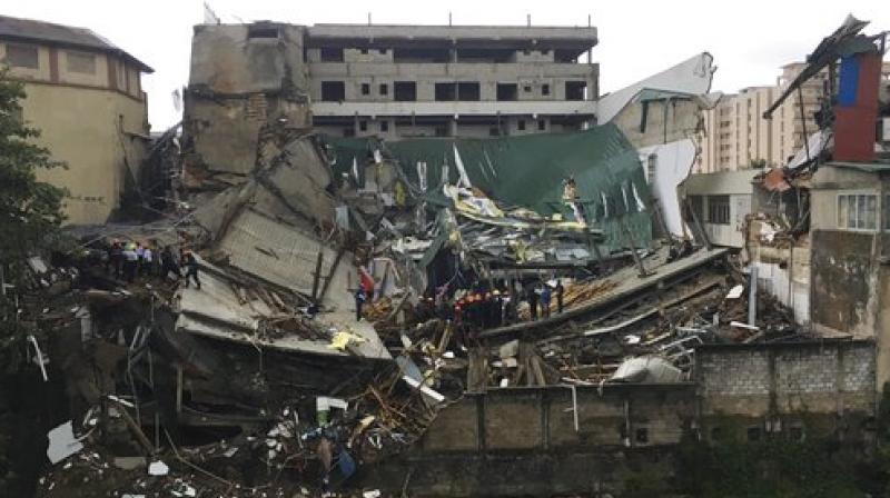 Sarath Wimalawardena, an eye-witness who works at a nearby construction site, said the building collapsed with a loud sound that was followed by an enormous cloud of dust. (Photo: AP) Sarath Wimalawardena, an eye-witness who works at a nearby construction site, said the building collapsed with a loud sound that was followed by an enormous cloud of dust. (Photo: AP)
