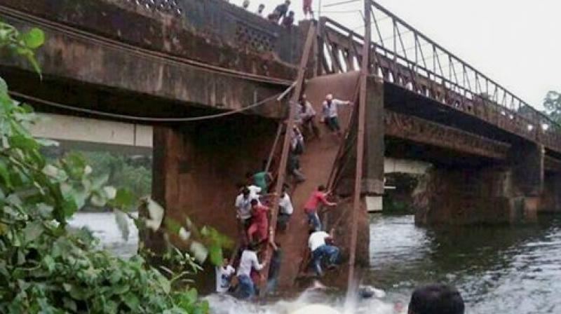Around 50 people had gathered on the bridge to watch the rescue efforts when it gave way and they plunged into the water. (Photo: PTI) Around 50 people had gathered on the bridge to watch the rescue efforts when it gave way and they plunged into the water. (Photo: PTI)