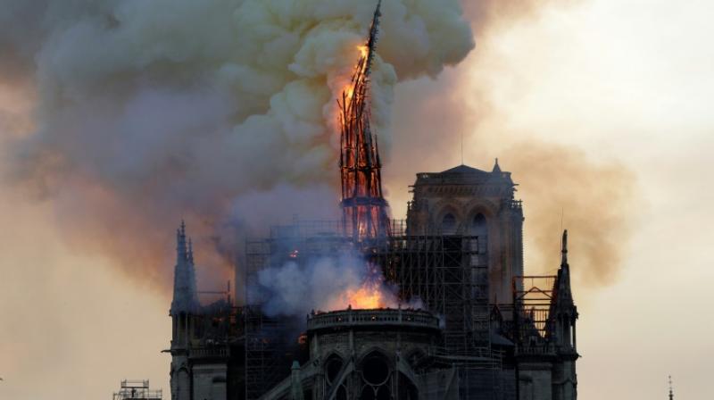 President Emmanuel Macron has vowed the emblematic monument will be rebuilt after its spire and roof collapsed Monday night in a blaze. (Photo: AFP) President Emmanuel Macron has vowed the emblematic monument will be rebuilt after its spire and roof collapsed Monday night in a blaze. (Photo: AFP)