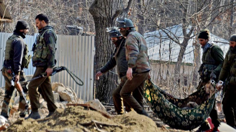 Special Operation Group of J&K police carrying the body of a militant that was recovered from the rubbles of destroyed house where militants were hiding during an encounter in Kulgam. (Photo: PTI) Special Operation Group of J&K police carrying the body of a militant that was recovered from the rubbles of destroyed house where militants were hiding during an encounter in Kulgam. (Photo: PTI)